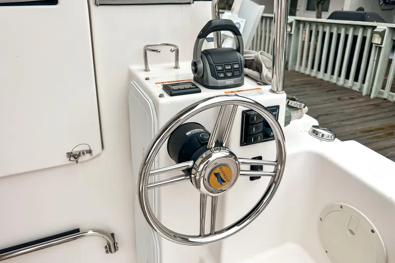 Slide: The Image of Steering wheel and controls of 2022 Cutwater 30 Command Bridge boat. - 6