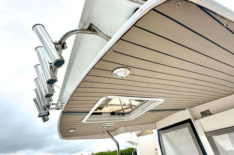 Slide: The Image of 2022 Cutwater 30 Command Bridge boat roof with rod holders and hatch. - 60