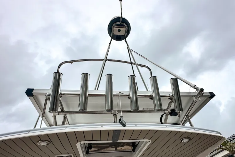 Slide: The Image of 2022 Cutwater 30 Command Bridge boat with stainless steel rod holders, viewed from below. - 9