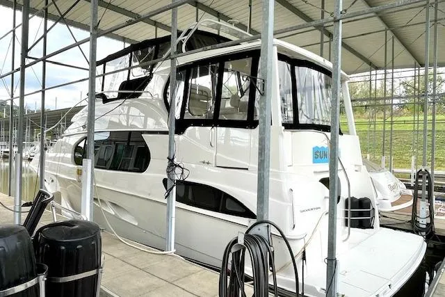 The Image of 2002 Silverton 43 Motor Yacht docked in a covered marina. - 1