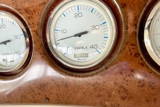 Slide: The Image of Close-up of 2002 Silverton 43 Motor Yacht RPM gauges on a wooden dashboard. - 11