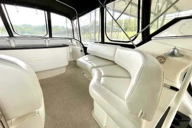 Slide: The Image of 2002 Silverton 43 Motor Yacht interior with plush seating and panoramic windows. - 13
