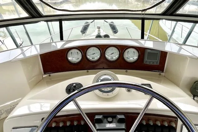 Slide: The Image of 2002 Silverton 43 Motor Yacht helm with gauges and steering wheel. - 20