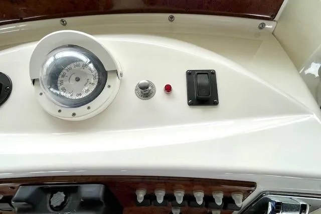 Slide: The Image of Control panel of a 2002 Silverton 43 Motor Yacht with gauges and switches. - 22
