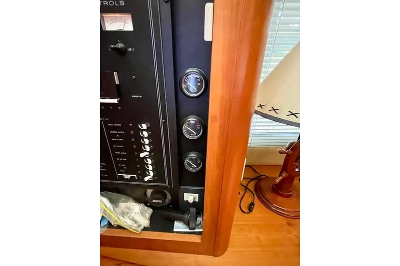 Slide: The Image of 2002 Silverton 43 Motor Yacht control panel with gauges and wooden interior. - 28