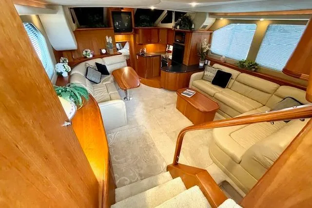 Slide: The Image of Luxurious interior of 2002 Silverton 43 Motor Yacht with elegant seating and wood finishes. - 29
