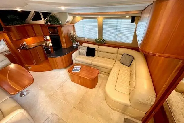 Slide: The Image of Luxurious interior of 2002 Silverton 43 Motor Yacht with plush seating and modern kitchen. - 30
