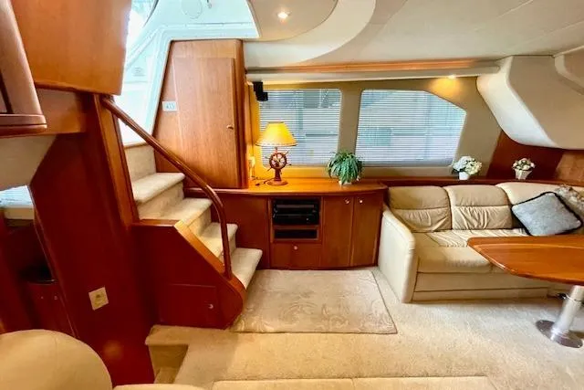 Slide: The Image of Luxurious interior of 2002 Silverton 43 Motor Yacht with elegant wood finishes and cozy seating. - 32