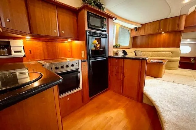 Slide: The Image of Luxurious interior of 2002 Silverton 43 Motor Yacht with modern kitchen and cozy seating area. - 35
