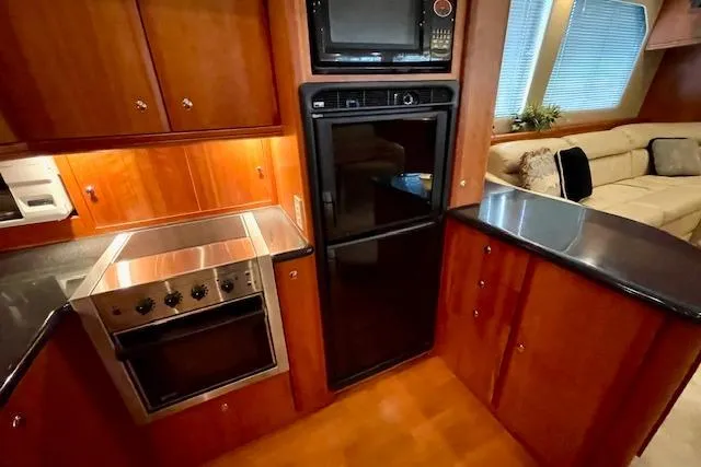 Slide: The Image of Luxurious kitchen interior of 2002 Silverton 43 Motor Yacht with modern appliances. - 37