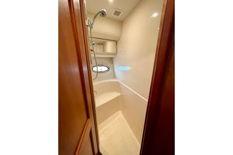 Slide: The Image of Shower area in 2002 Silverton 43 Motor Yacht with wooden door and porthole window. - 42