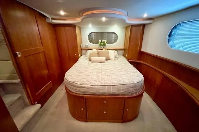 Slide: The Image of Luxurious bedroom interior of 2002 Silverton 43 Motor Yacht with elegant wood paneling. - 45