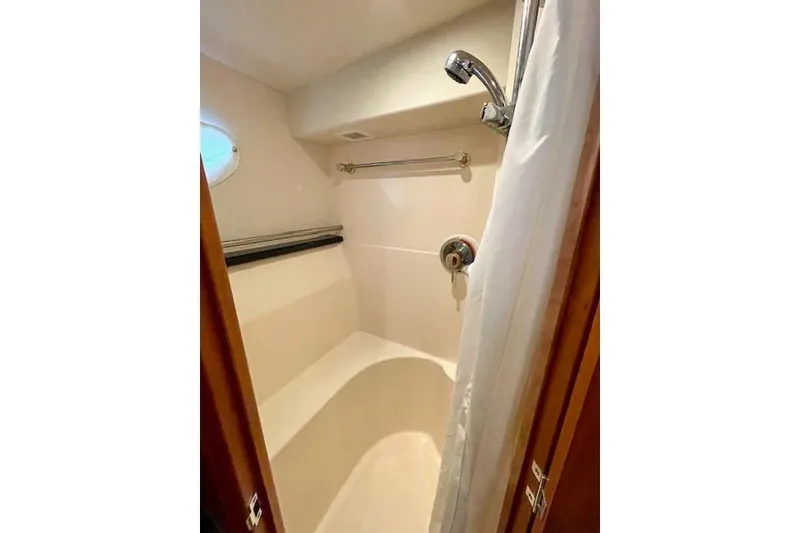 Slide: The Image of Bathroom interior of 2002 Silverton 43 Motor Yacht with shower and porthole. - 48
