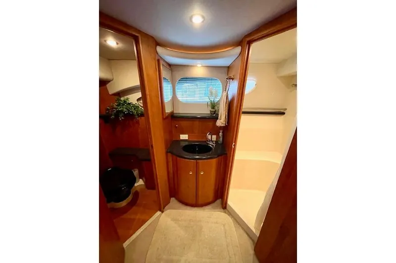 Slide: The Image of Luxurious bathroom interior of 2002 Silverton 43 Motor Yacht with wood accents and modern fixtures. - 49