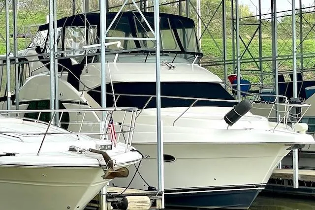 Slide: The Image of 2002 Silverton 43 Motor Yacht docked in a marina, surrounded by other boats. - 5