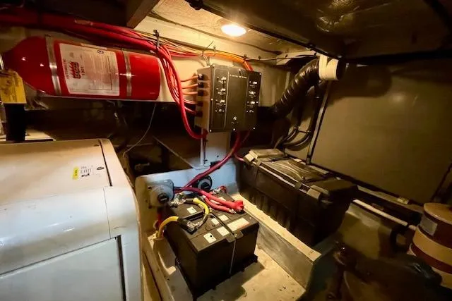 Slide: The Image of Engine room of 2002 Silverton 43 Motor Yacht with batteries and fire extinguisher. - 55