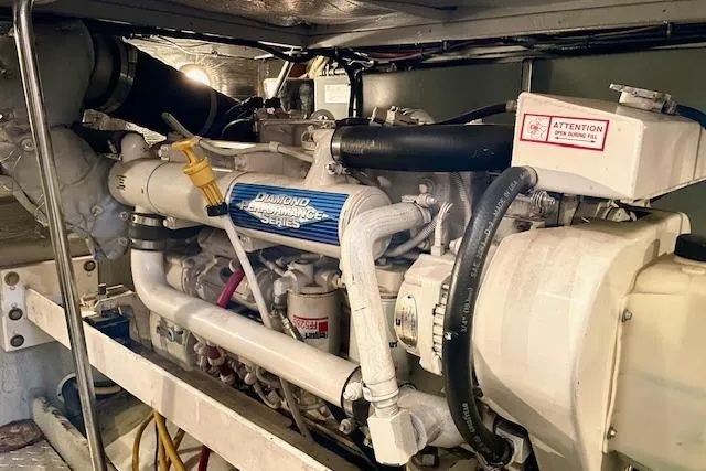 Slide: The Image of Engine room of a 2002 Silverton 43 Motor Yacht, showcasing a Diamond Performance Series engine. - 62