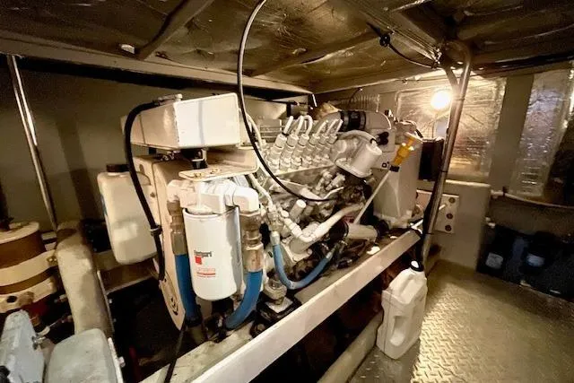Slide: The Image of Engine room of 2002 Silverton 43 Motor Yacht, showcasing mechanical components and systems. - 64