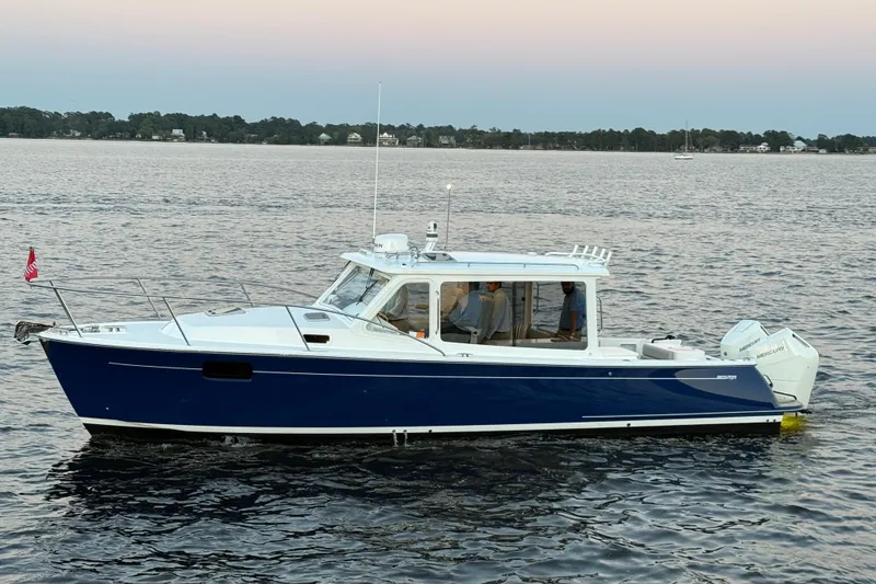 The Image of 2026 MJM 38RS boat on calm water at sunset, featuring sleek design and modern features. - 0