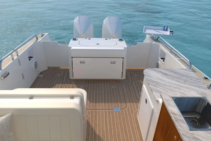 Slide: The Image of 2026 MJM 38RS boat deck with dual engines, sink, and seating on calm water. - 3