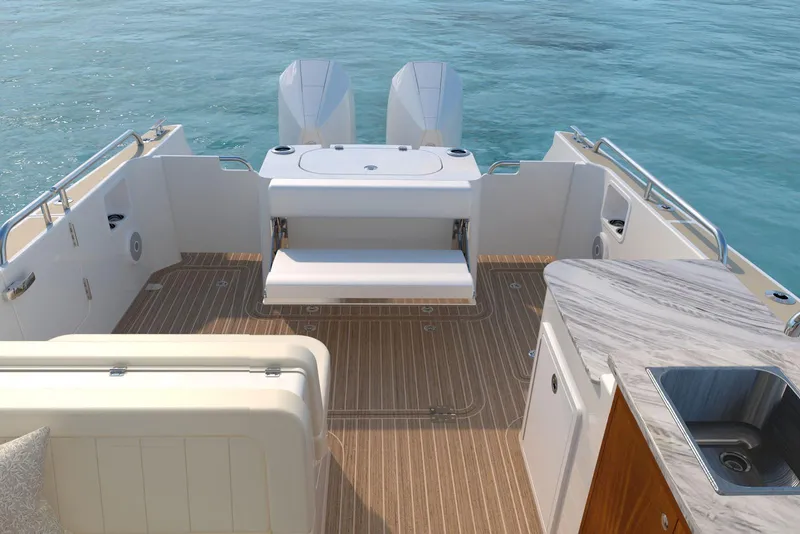 Slide: The Image of Luxury MJM 38RS 2026 boat deck with seating, sink, and twin engines on calm water. - 4
