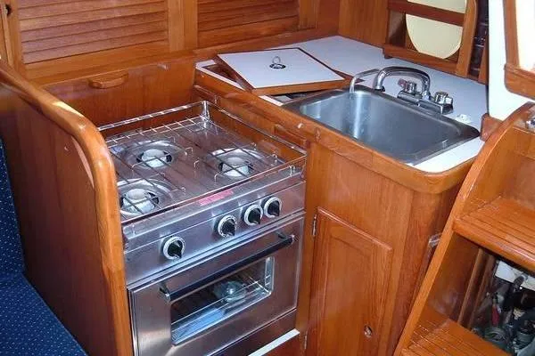 Slide: The Image of 1985 Bristol 31.1 Keel Center Board yacht kitchen with stove and sink. - 2