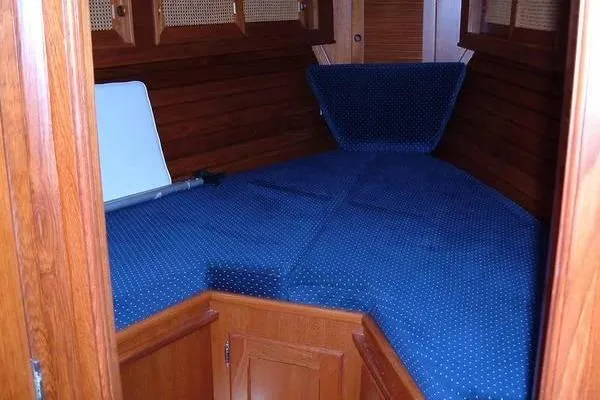 Slide: The Image of Interior cabin of 1985 Bristol 31.1 Keel Center Board sailboat with blue upholstery. - 4