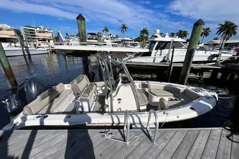 Slide: The Image of 2024 Key West 219 FS boat docked at marina with clear blue sky. - 2