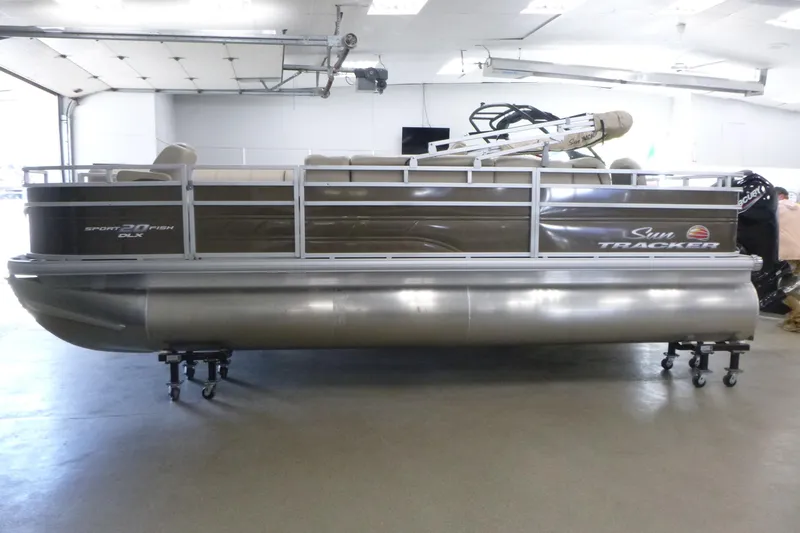 The Image of 2024 Sun Tracker SportFish 20 DLX pontoon boat in a showroom setting. - 1