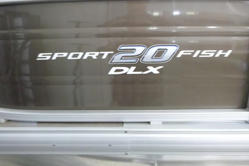 Slide: The Image of 2024 Sun Tracker SportFish 20 DLX logo on boat exterior. - 15