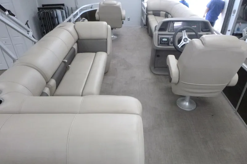 Slide: The Image of 2024 Sun Tracker SportFish 20 DLX interior with beige seating and steering console. - 4