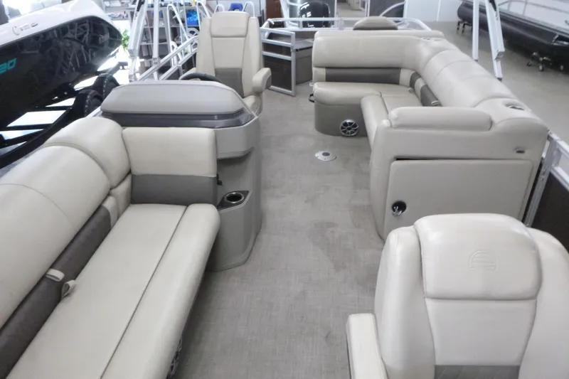 Slide: The Image of 2024 Sun Tracker SportFish 20 DLX pontoon boat interior with beige seating and spacious layout. - 5