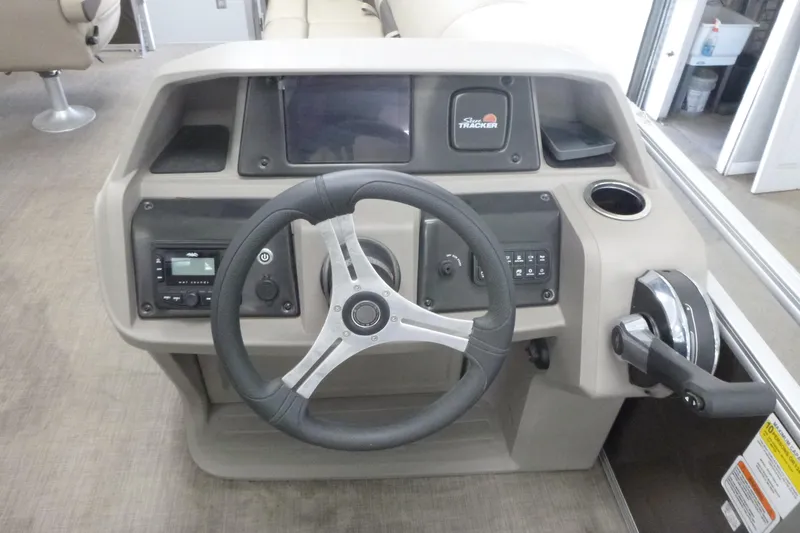 Slide: The Image of 2024 Sun Tracker SportFish 20 DLX dashboard with steering wheel and controls. - 7