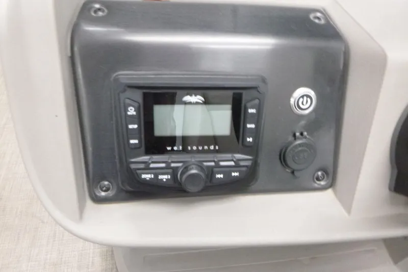 Slide: The Image of 2024 Sun Tracker SportFish 20 DLX audio control panel with power button and display. - 8