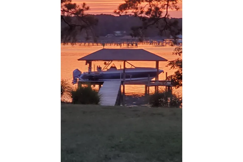 Slide: The Image of 2022 Intrepid 327-I CC boat on trailer under clear blue sky. - 1