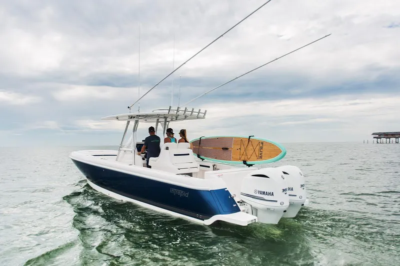 Slide: The Image of 2022 Intrepid 327-I CC boat dashboard with steering wheel and control panel. - 10