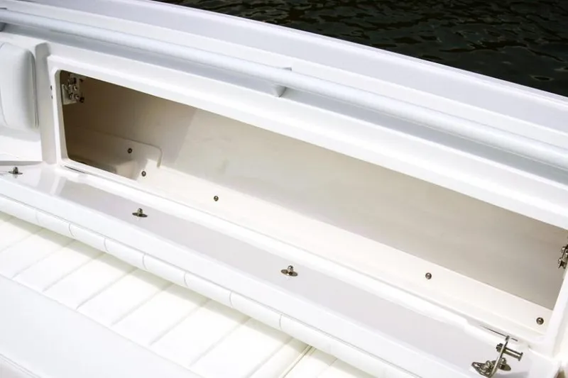 Slide: The Image of White cushioned seating on 2022 Intrepid 327-I CC boat, featuring blue accent stitching. - 17