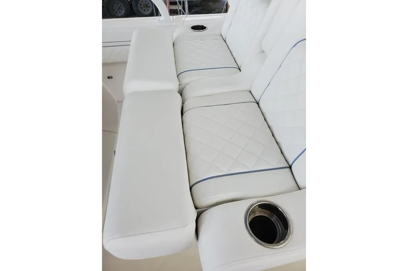 Slide: The Image of 2022 Intrepid 327-I CC boat on trailer under clear blue sky. - 2