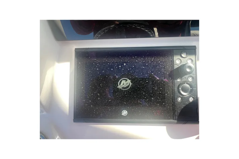 Slide: The Image of 2022 Intrepid 327-I CC boat dashboard with electronic display and control panel. - 24