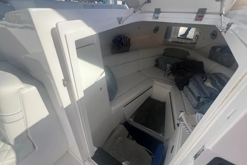 Slide: The Image of 2022 Intrepid 327-I CC cabin interior with white seating and storage space. - 27