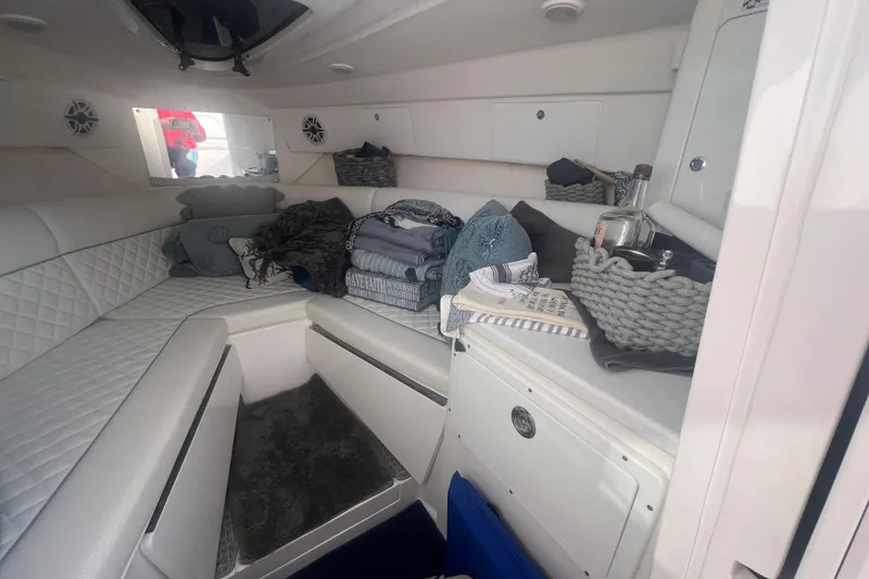 Slide: The Image of Interior of 2022 Intrepid 327-I CC boat with cozy seating and storage baskets. - 28