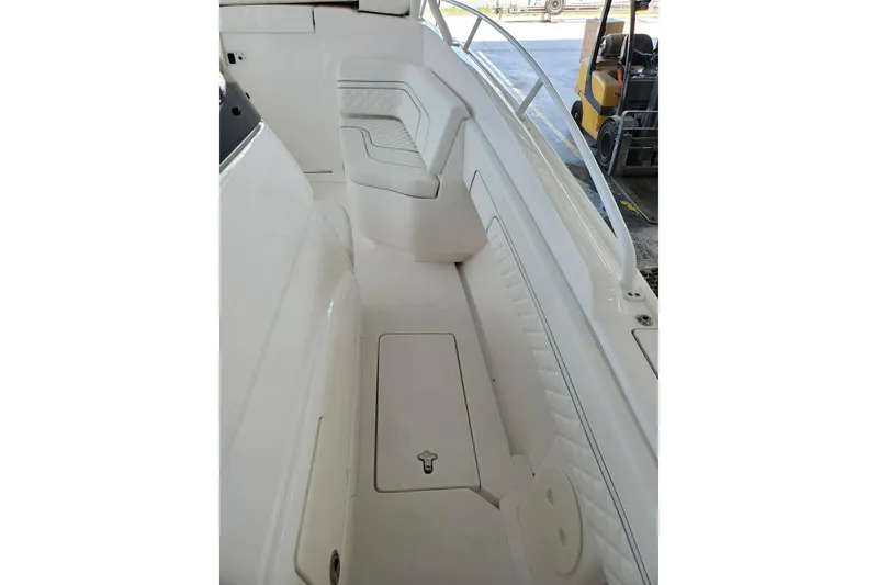 Slide: The Image of 2022 Intrepid 327-I CC boat docked at sunset, serene waterfront view. - 3