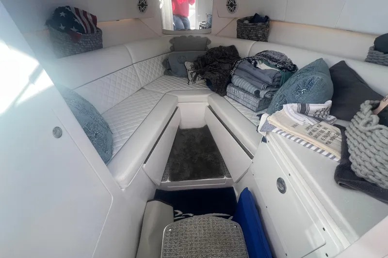 Slide: The Image of 2022 Intrepid 327-I CC cabin interior with white seating and decorative pillows. - 30