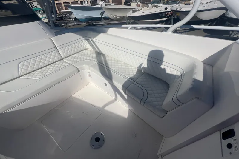 Slide: The Image of Interior of 2022 Intrepid 327-I CC boat with white quilted seating. - 32