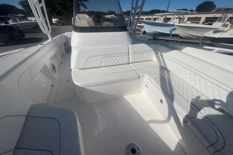 Slide: The Image of 2022 Intrepid 327-I CC boat interior with white seating and modern design. - 33