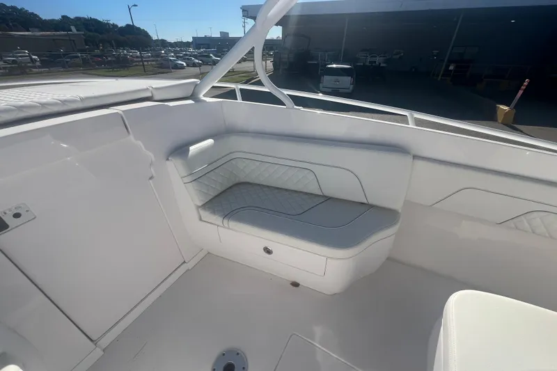 Slide: The Image of 2022 Intrepid 327-I CC boat interior with white cushioned seating. - 34