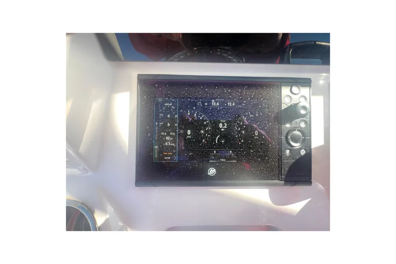 Slide: The Image of 2022 Intrepid 327-I CC boat dashboard with digital display and controls. - 35