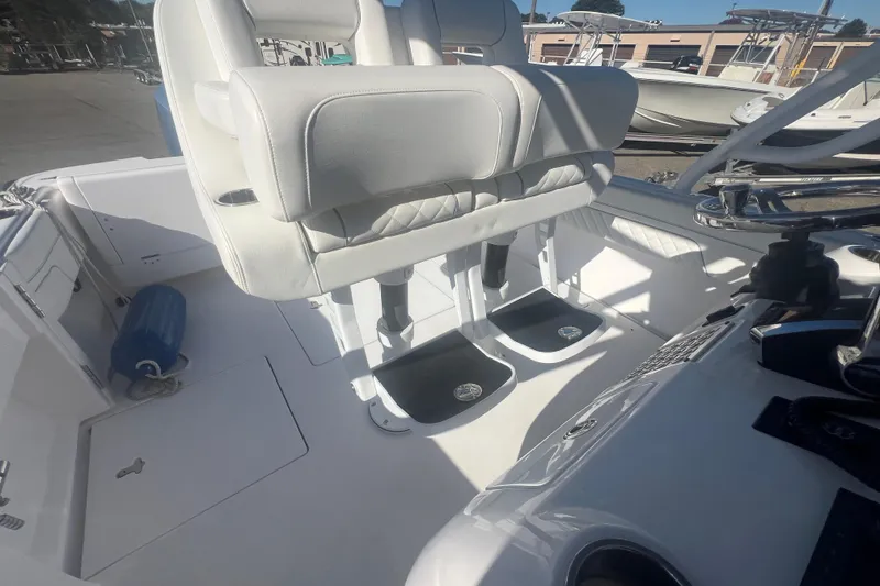 Slide: The Image of 2022 Intrepid 327-I CC boat interior with white seating and helm station. - 37