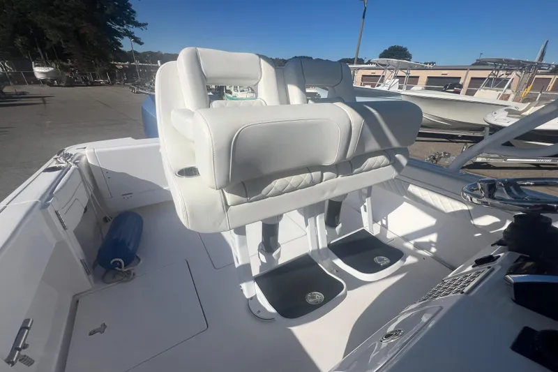 Slide: The Image of 2022 Intrepid 327-I CC boat interior with white seating and helm station. - 38