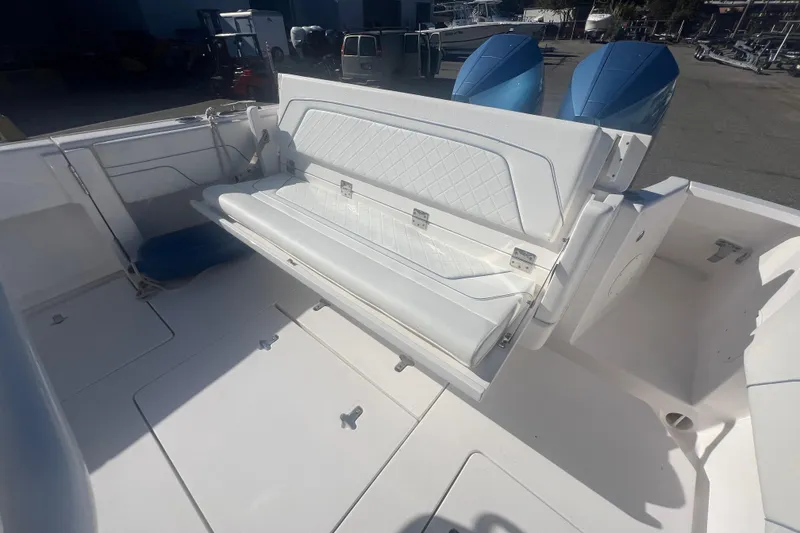 Slide: The Image of 2022 Intrepid 327-I CC boat with foldable seating and dual outboard engines. - 40